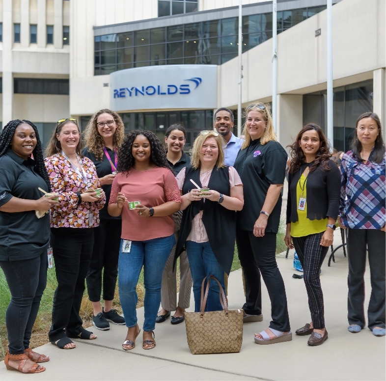 Members of the Veterans Employee Resource Group, one of Reynolds American's diversity and inclustion programs, standing outside holding ice cream cups.