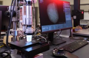 Microscope beside a computer
