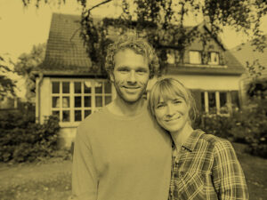 Man and Woman in front of house