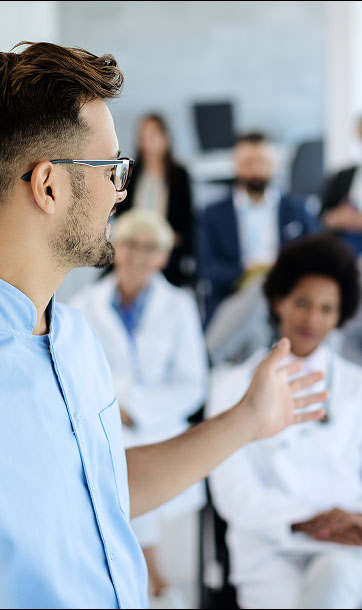Man speaking to group of adults